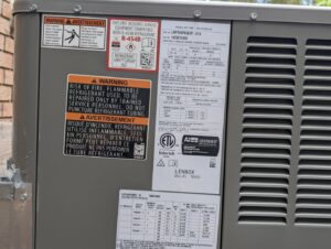 A close-up of the specification label on a Lennox outdoor air conditioning unit, installed or serviced by Pardee Service Experts in Charleston, SC.