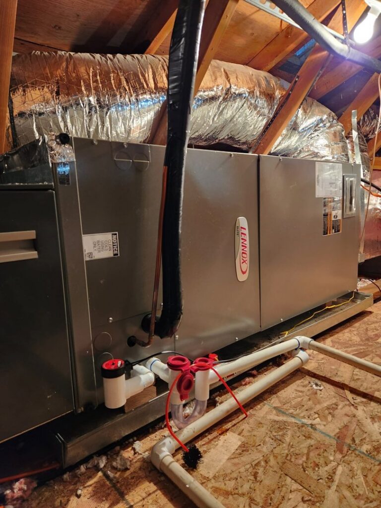 A Lennox air handler unit installed in an attic with ductwork by Alpine Heating in Eugene, OR.