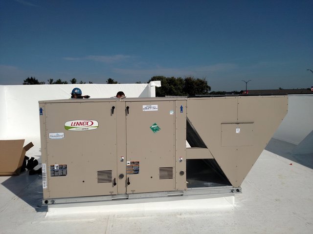 A large Lennox commercial HVAC rooftop unit being installed or serviced by Benck Mechanical Inc in Somerset, WI.