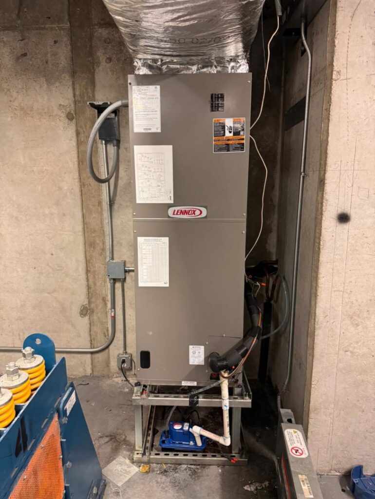 An indoor Lennox commercial HVAC air handler unit with ductwork installed by ProTexAir HVAC Services in Houston, TX.
