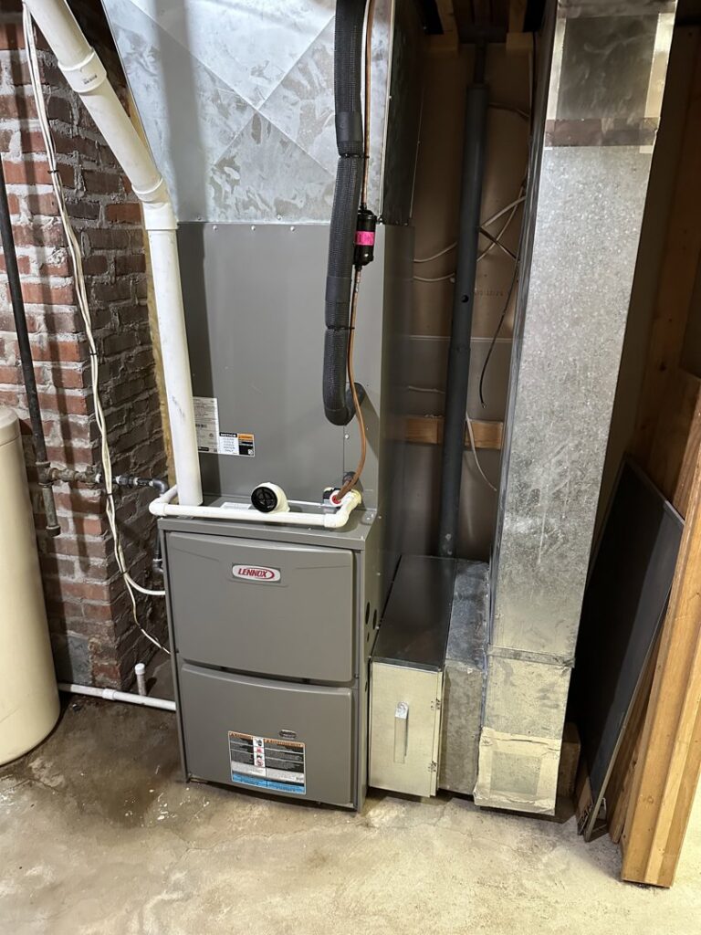 A Lennox furnace and ductwork installed in a basement by Great Plains Heating & Air in Goddard, KS.