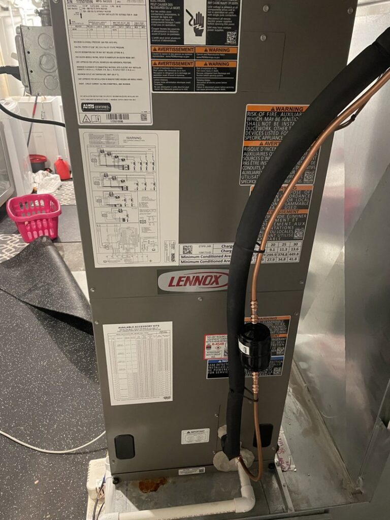 Close-up of a Lennox furnace installation showing piping and wiring by Cyber Heating and Cooling in Bloomington, MN.