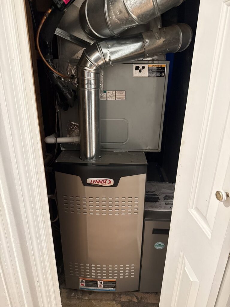 A Lennox furnace and air handler unit installed in a utility closet by Central Heating & Air Conditioning in Billings, MT