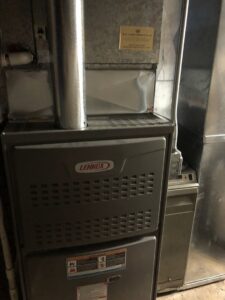 A close-up of a Lennox furnace, likely during installation or service by Modern HVAC Technology in Chicago, IL.