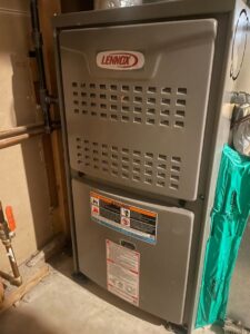 A Lennox furnace unit installed in a utility room, ready for operation by Crain Heating and Cooling in Jeffersonville, IN.