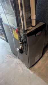 A Lennox furnace with intricate piping and ductwork installed by Heating and Cooling Drs of Waukesha, Pewaukee, and Delafield, Waukesha, WI.