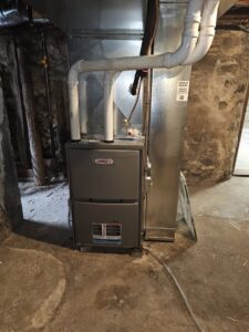 A Lennox furnace installed in a basement with rustic stone walls by Heating and Cooling Drs of Waukesha, Pewaukee, and Delafield, Waukesha, WI.