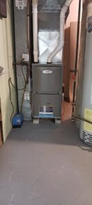 A Lennox furnace installed next to a water heater by Heating and Cooling Drs of Waukesha, Pewaukee, and Delafield, Waukesha, WI.