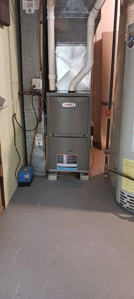 A Lennox furnace installed next to a water heater by Heating and Cooling Drs of Waukesha, Pewaukee, and Delafield, Waukesha, WI.