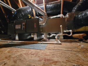 A Lennox HVAC air handler unit with ductwork installed in an attic by DeHart Plumbing, Heating, & Air in Sparks, NV