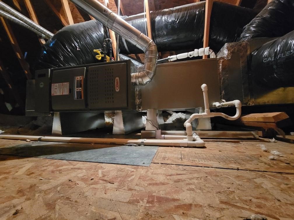 A Lennox HVAC air handler unit with ductwork installed in an attic by DeHart Plumbing, Heating, & Air in Sparks, NV