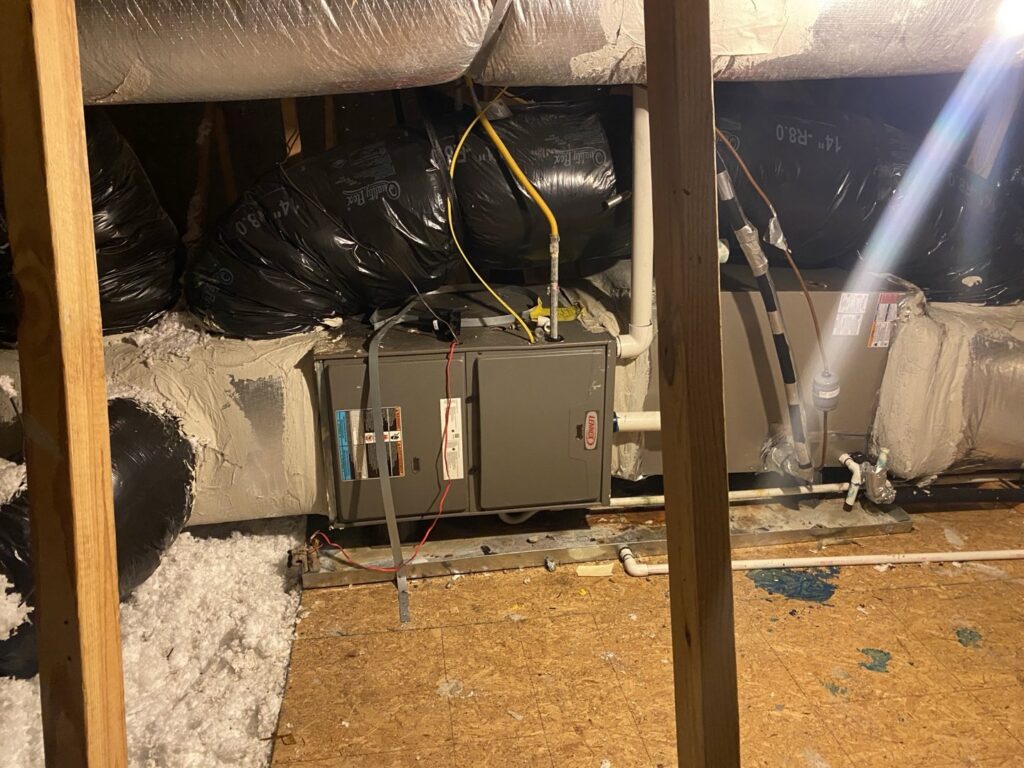 A Lennox HVAC air handler unit installed in an attic with ductwork and insulation by Reasonable Air, LLC in Summerville, SC.