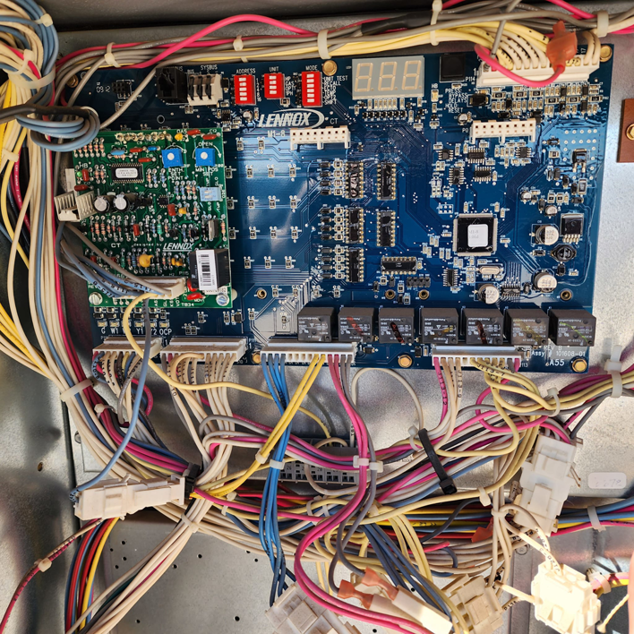 A close-up view of a Lennox HVAC control board with intricate wiring by Air Factory Heating & Cooling Company in Oklahoma City, OK.