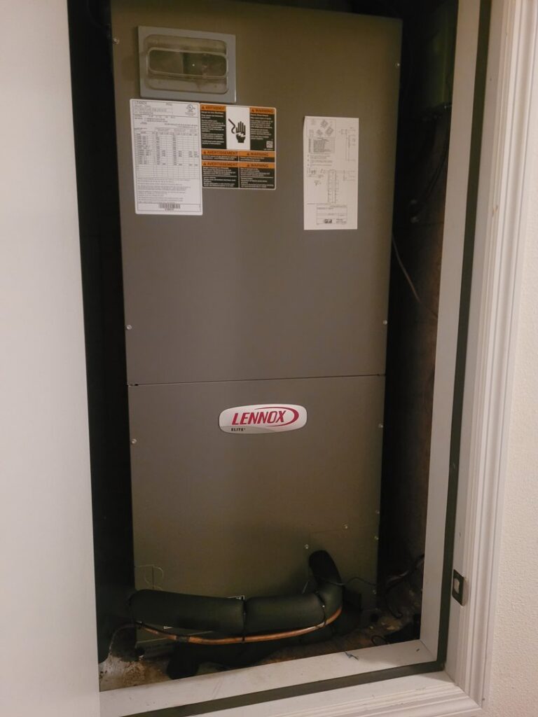 A Lennox HVAC furnace or air handler unit installed in a closet by Integrity Services Heating and Cooling in Madison, AL.