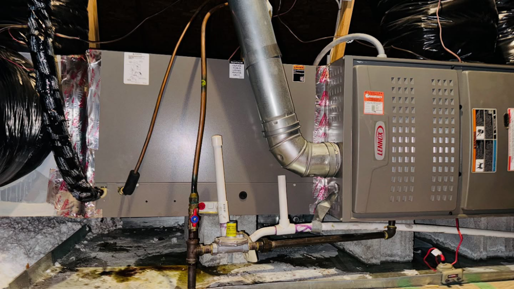 An indoor Lennox HVAC furnace and ductwork installed in a utility area by Ortez Home Services LLC in Charlotte, NC.
