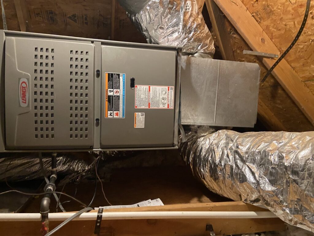 A Lennox HVAC system and ductwork installed in an attic, demonstrating professional service by Rhino Heating and Air Conditioning LLC in Norman, OK.