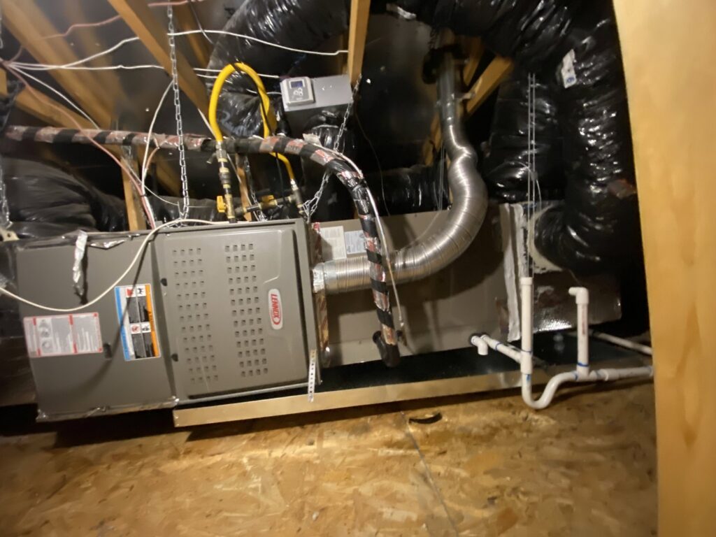 A Lennox HVAC unit with extensive ductwork and wiring installed in an attic by Steadfast Mechanical in Gilbert, AZ.