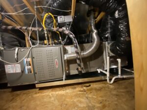 A Lennox HVAC unit with extensive ductwork and wiring installed in an attic by Steadfast Mechanical in Gilbert, AZ.