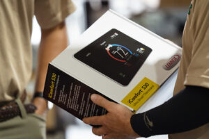 A Lennox iComfort S30 ultra smart thermostat box being held by a technician from Seven Level Services Inc in Cape Coral, FL.