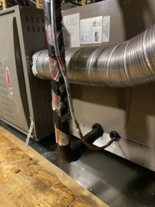 A Lennox indoor HVAC unit with connected ductwork and copper lines by Steadfast Mechanical in Gilbert, AZ.