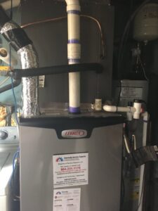 An indoor Lennox HVAC unit with an Eveready Service Experts sticker in Henrico, VA.