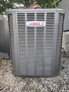 A close-up view of a Lennox outdoor AC condenser unit, representing services by Competition A/C & Heat, LLC in Corpus Christi, TX