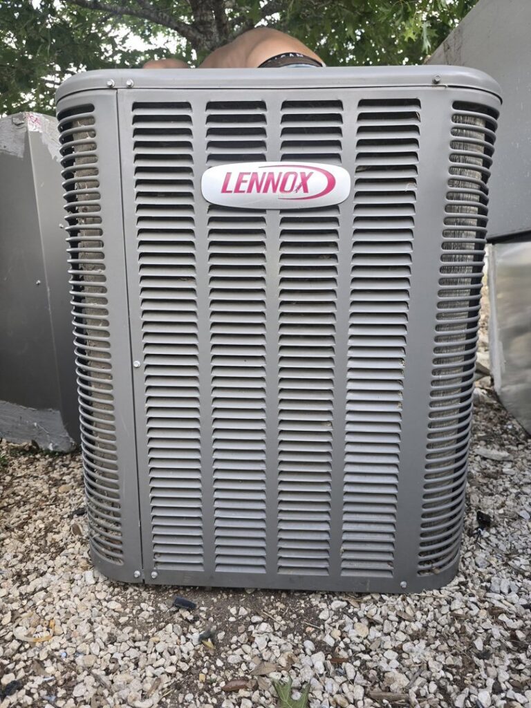 A close-up view of a Lennox outdoor AC condenser unit, representing services by Competition A/C & Heat, LLC in Corpus Christi, TX