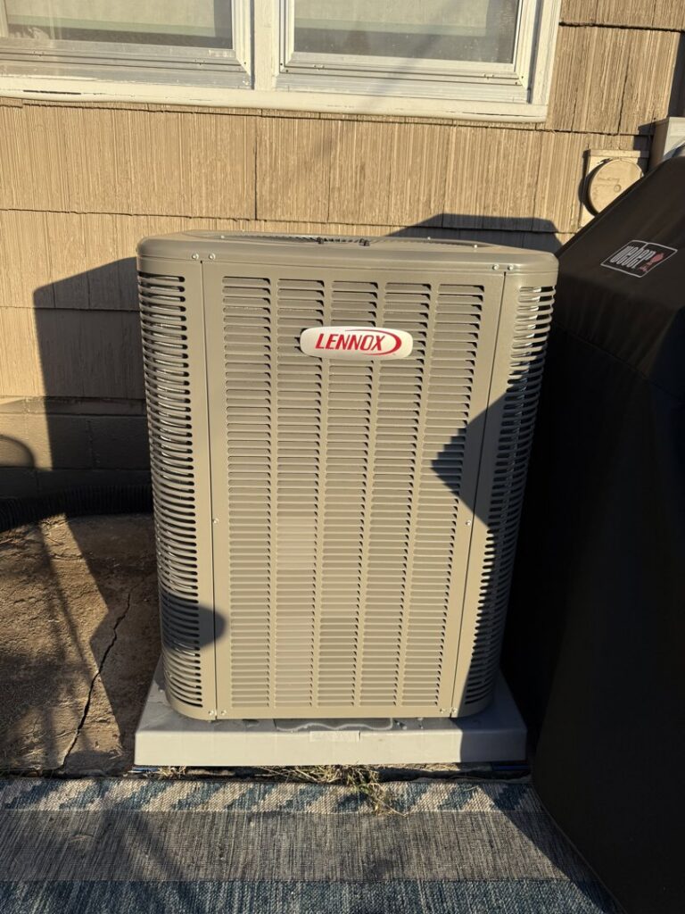 A modern Lennox outdoor air conditioning unit installed by Apollo Heating and Air in Bellevue, NE.
