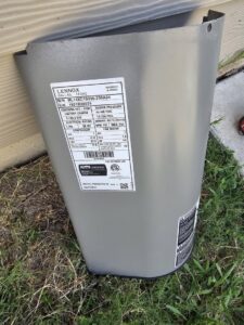 A close-up of a Lennox outdoor AC unit's data plate, showing model and serial numbers, serviced by MasterCraft Mechanical, LLC. in Haslet, TX.