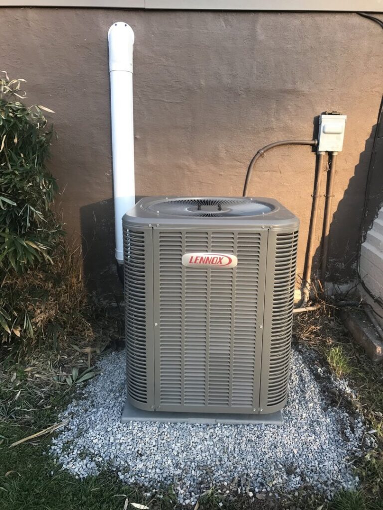 A Lennox outdoor air conditioning unit installed on a gravel bed by Strine's Heating & A/C in York, PA.