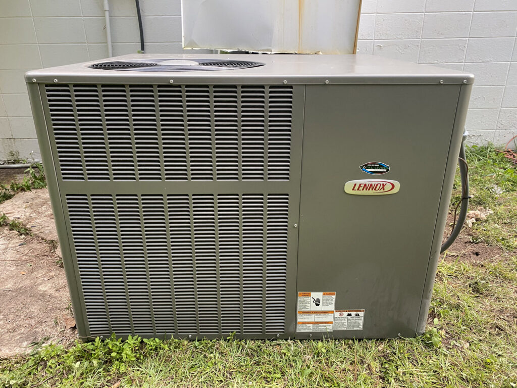 A Lennox outdoor air conditioning unit installed at a property by Total Living Comfort in Irvington, AL.