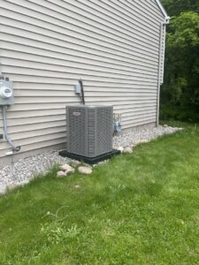 A Lennox outdoor air conditioner installed at a home by Isaac Heating & Air Conditioning in Rochester, NY.