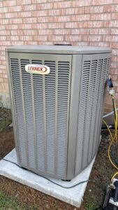 A Lennox outdoor HVAC unit being serviced with gauges by Modern Air Services in Fort Worth, TX.