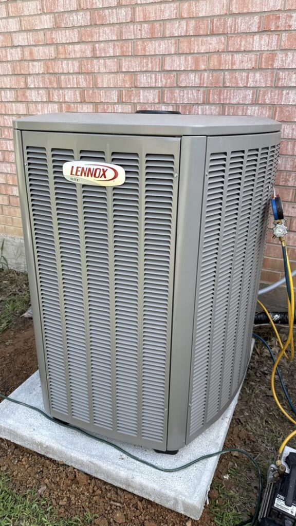 A Lennox outdoor HVAC unit being serviced with gauges by Modern Air Services in Fort Worth, TX.