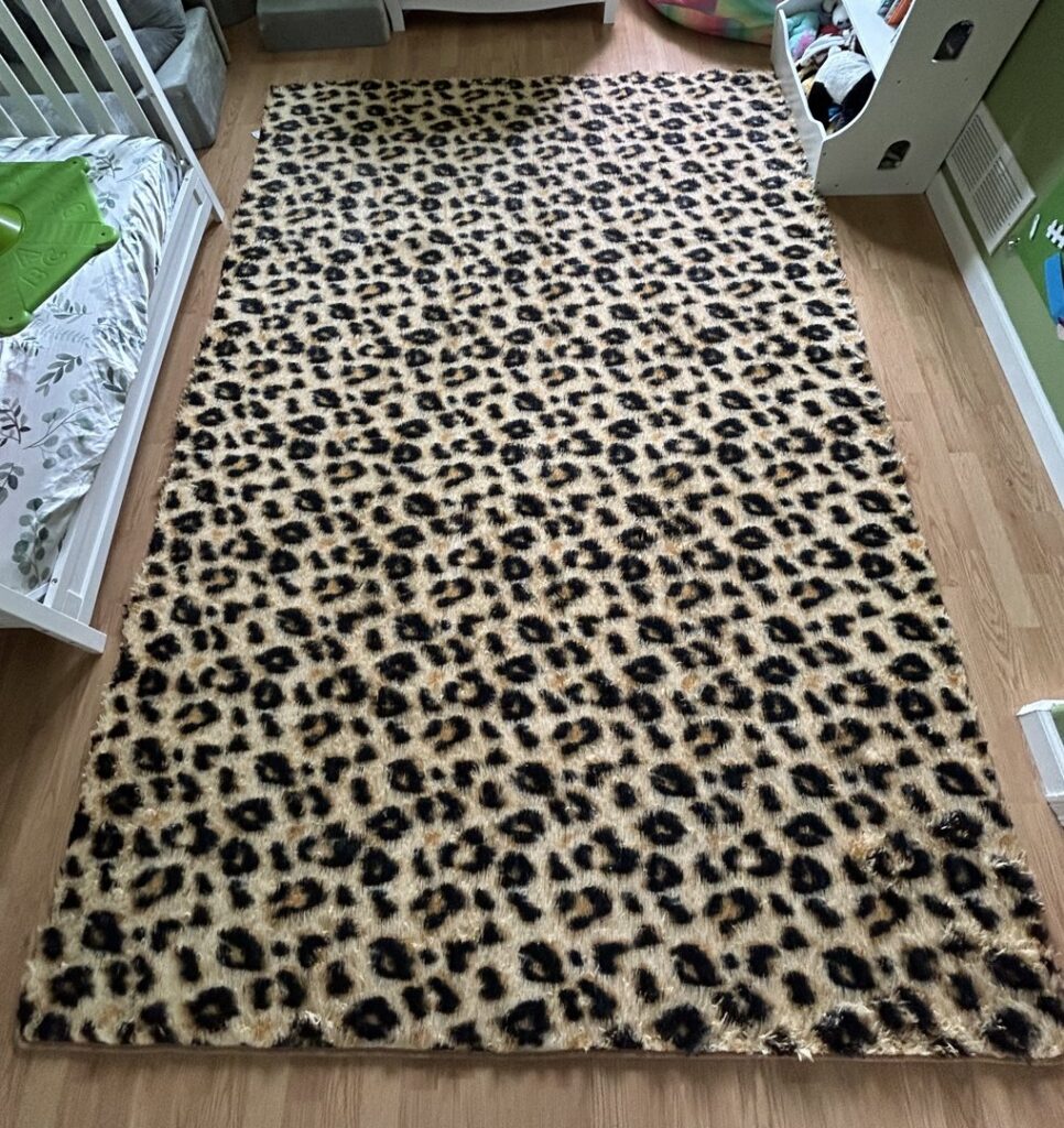 A large leopard print area rug on a wooden floor, ready for professional cleaning by Elite Cleaning Services in Elgin, IL