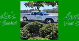 A white service truck for Leslie's Pest Control, ready for a job in Tuscaloosa, AL