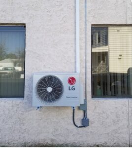 An LG Smart Inverter mini-split outdoor condenser unit installed on a building wall by Batista Heating & Cooling, LLC in Charlotte, NC.