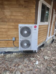 An LG mini-split condenser unit installed on the side of a house by Aces of Air Inc. in Georgetown, KY.