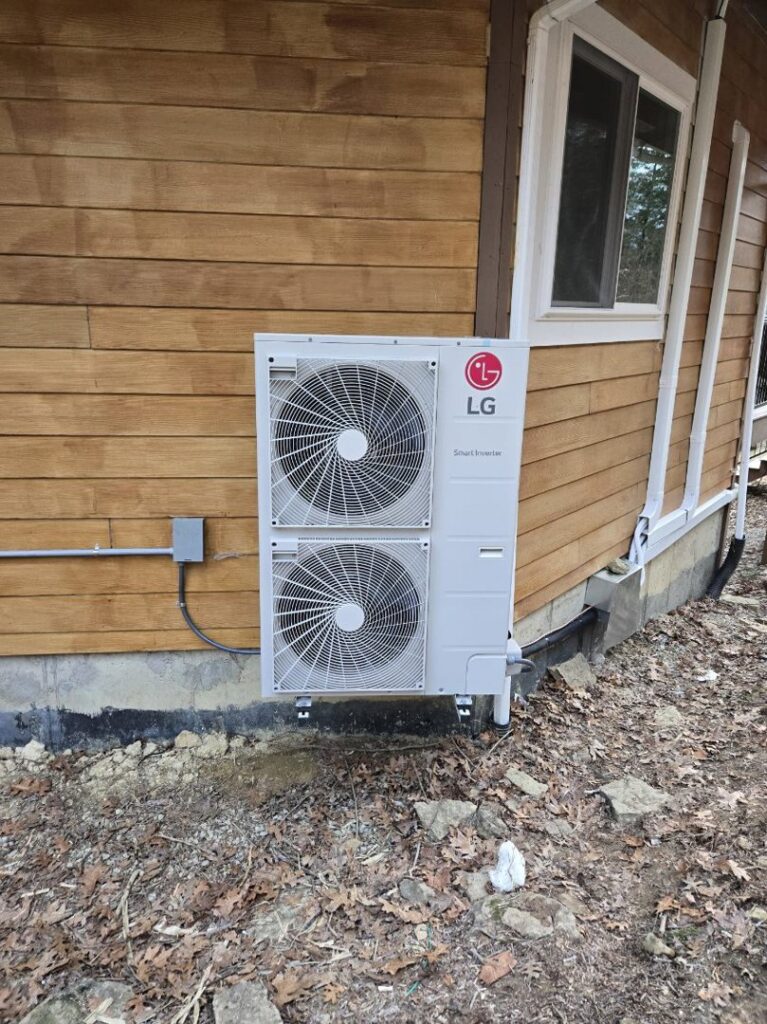 An LG mini-split condenser unit installed on the side of a house by Aces of Air Inc. in Georgetown, KY.