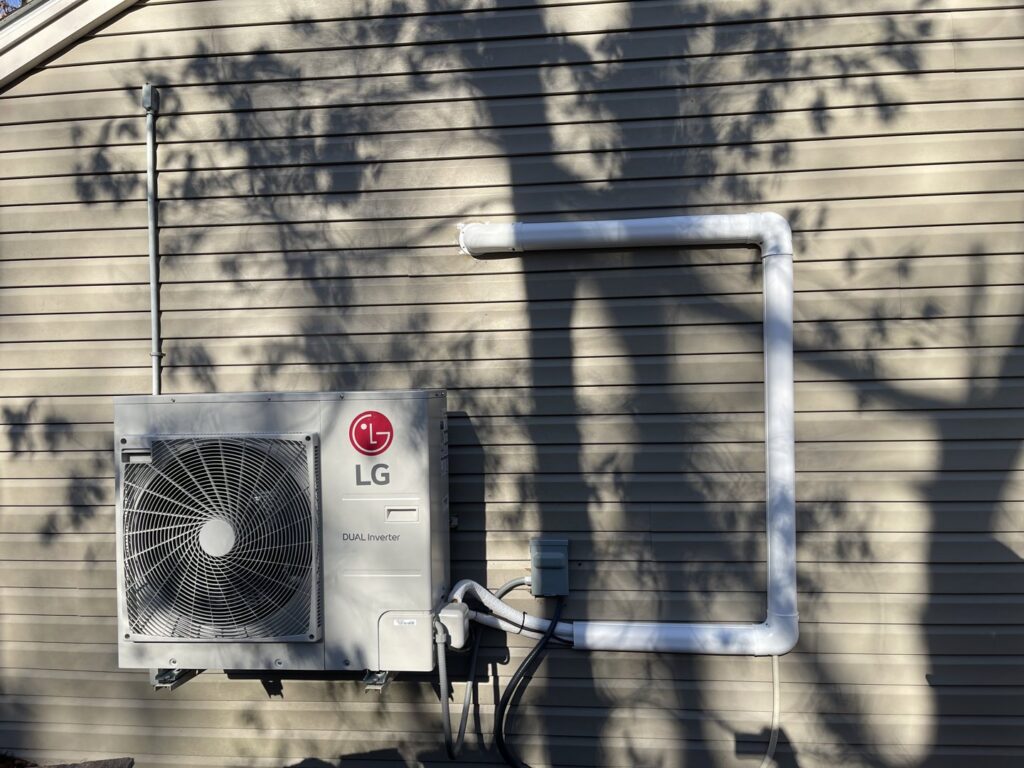 An LG mini-split heat pump outdoor unit installed on a home by Ferreira Mechanical, LLC in Fall River, MA