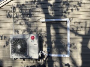 An LG mini-split heat pump outdoor unit installed on a home by Ferreira Mechanical, LLC in Fall River, MA