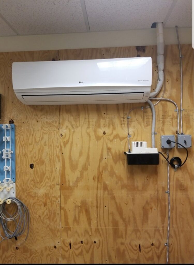An LG Smart Inverter mini-split indoor unit installed on a wooden wall by Batista Heating & Cooling, LLC in Charlotte, NC.