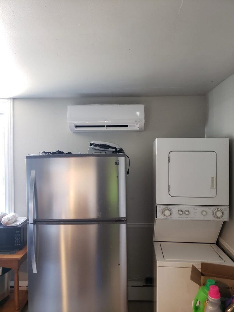An LG mini-split indoor unit installed above appliances in a kitchen area by Tack Mechanical LLC in Baltimore, MD.