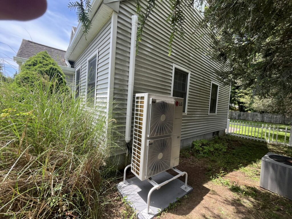 An LG outdoor HVAC unit installed next to a residential building by DND Mechanical in Columbus, OH.