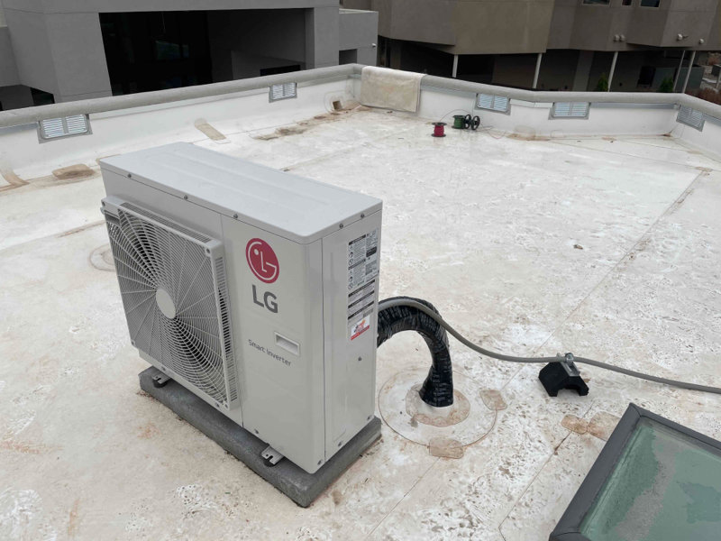 An LG Smart Inverter HVAC outdoor unit installed on a rooftop by Number 1 Plumber in Washington, DC.