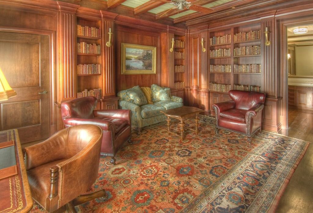 A classic library room featuring a beautiful area rug, showcasing an installation by Woven Legends in Philadelphia, PA.
