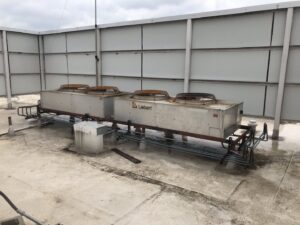 Large Liebert commercial HVAC units on a rooftop, serviced by Raleigh Comfort Services in Raleigh, NC.
