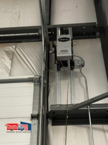 A close-up of a LiftMaster commercial garage door opener and its chain drive system installed by QuickFix Garage Door Service in Brighton, MA.