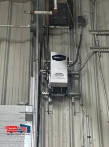 A detailed view of a LiftMaster commercial garage door opener system installed by QuickFix Garage Door Service in Brighton, MA.
