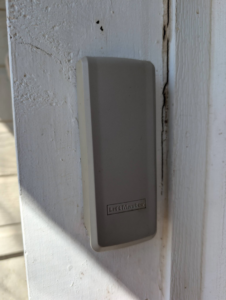 A close-up of a LiftMaster garage door keypad or sensor cover installed by Garage Doors & Remodeling LLC in Blue Springs, MO